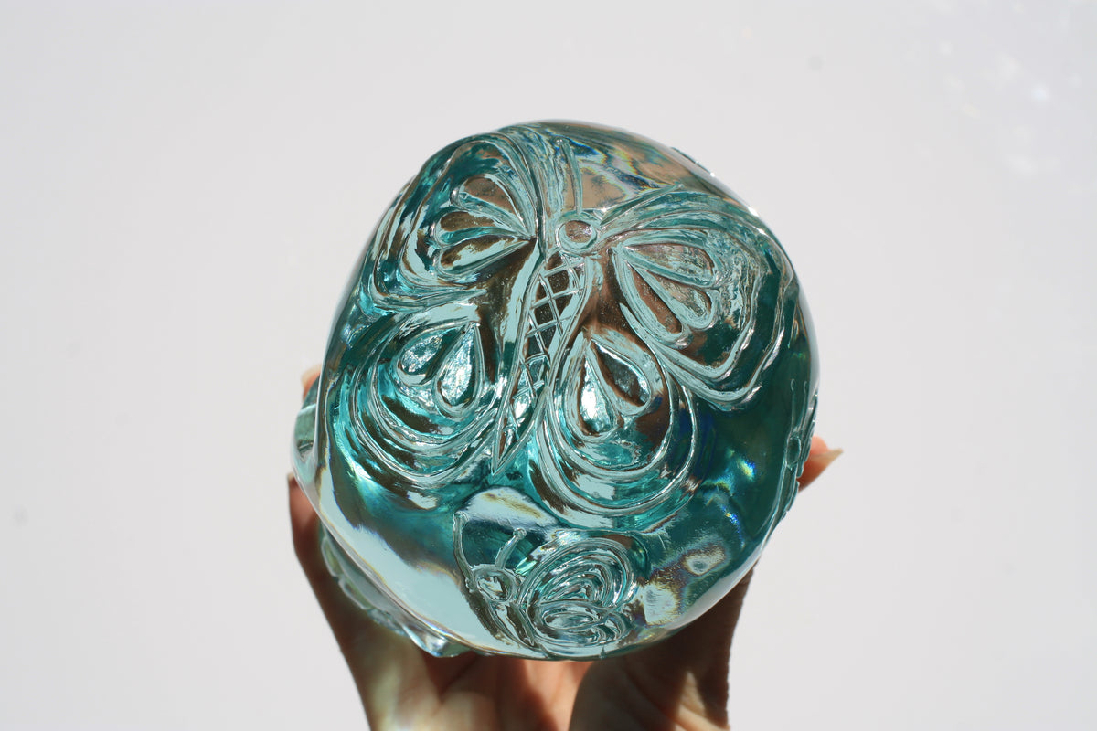 Blue obsidian crystal skull with hand engraved butterfly designs