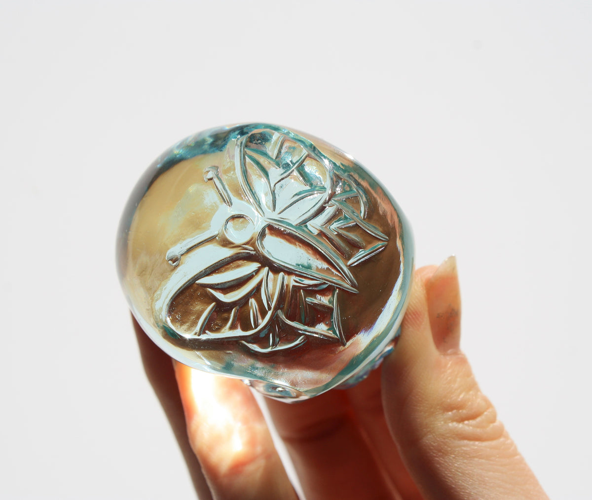 Blue obsidian crystal skull with hand‑engraved butterfly designs by artisan Vikas Meena.