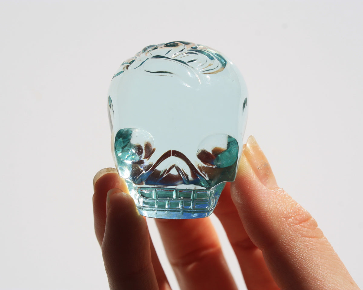 Blue obsidian crystal skull with hand engraved butterfly designs
