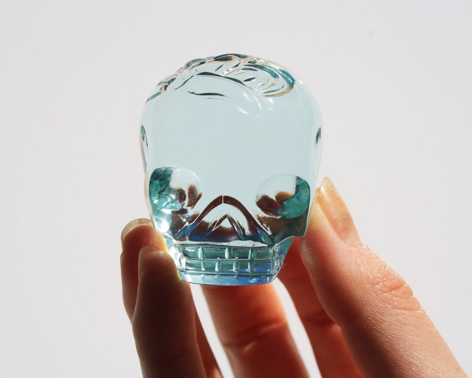Blue obsidian crystal skull with hand engraved butterfly designs