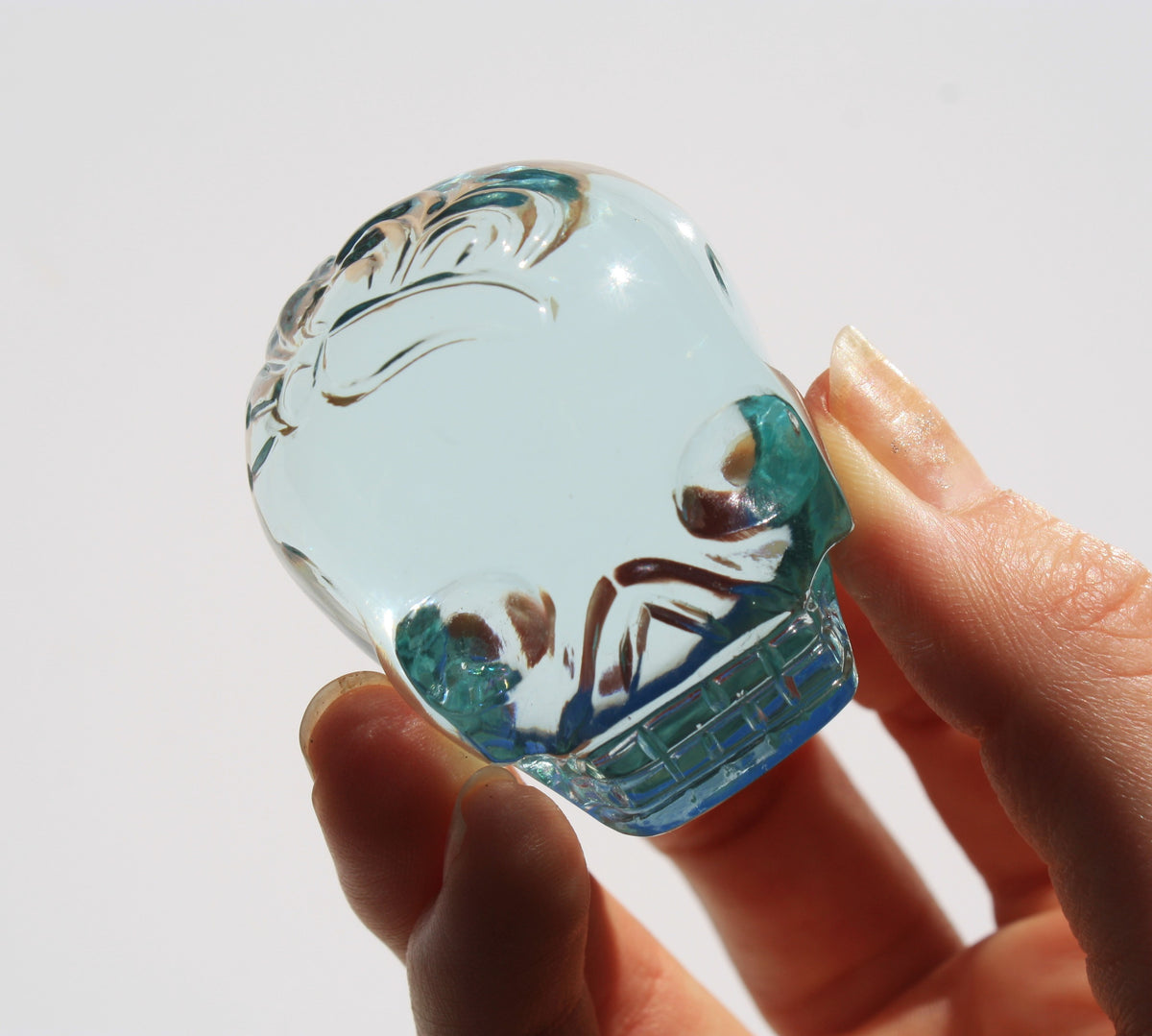 Blue obsidian crystal skull with hand engraved butterfly designs