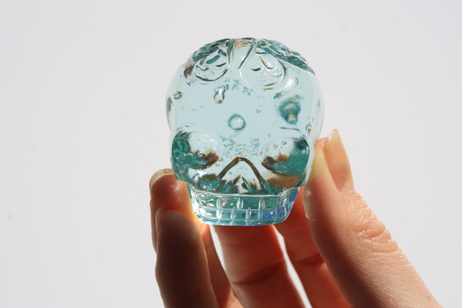 Blue obsidian crystal skull with hand engraved butterfly designs