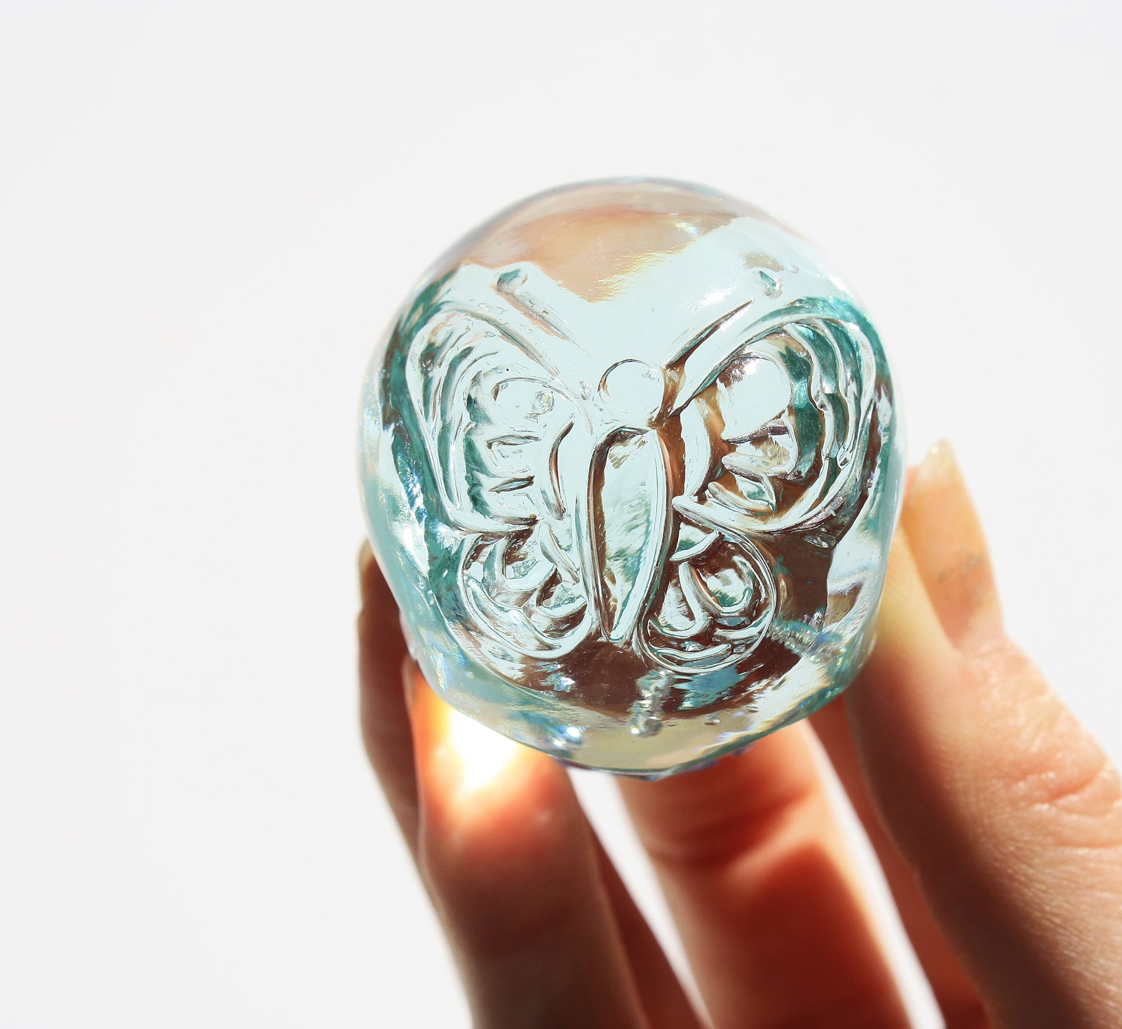 Blue obsidian crystal skull with hand engraved butterfly designs