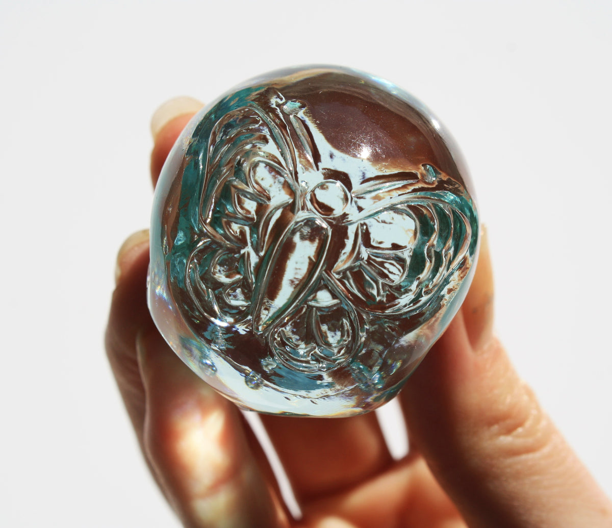 Blue obsidian crystal skull with hand engraved butterfly designs