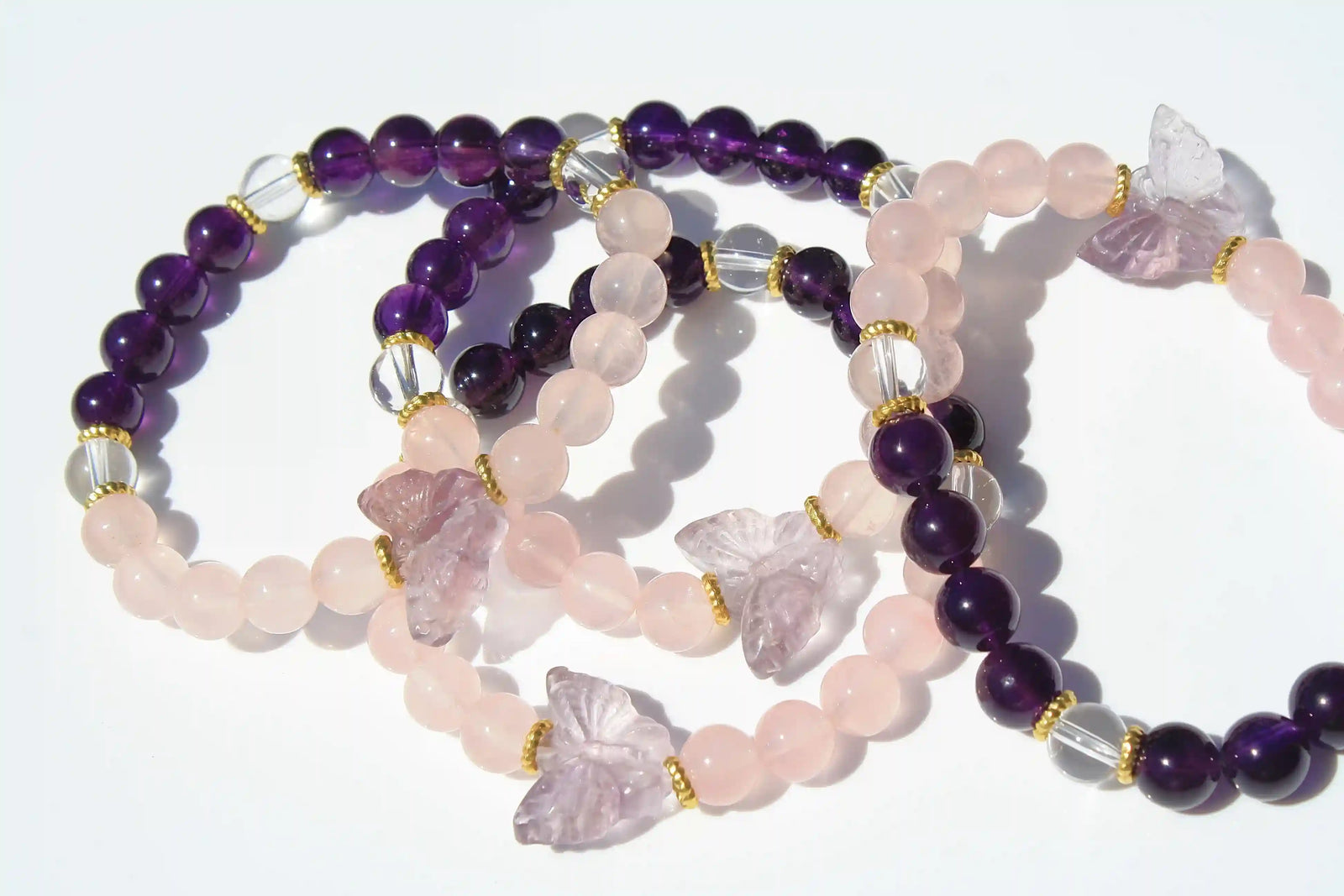 Beaded crystal bracelet with rose quartz and amethyst crystal and butterfly charms 