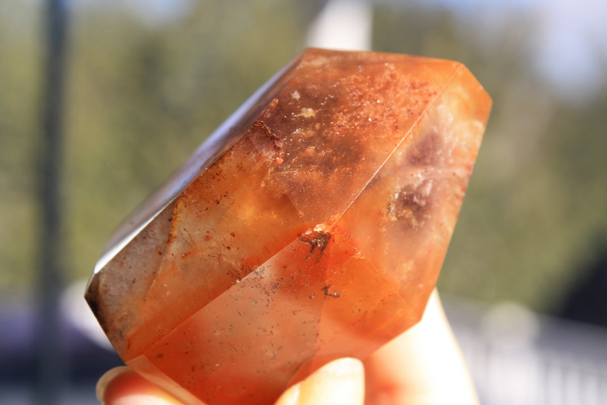 Red Dreamcoat Lemurian seed quartz tower with Super 7 inclusions and a Lemurian quartz core.