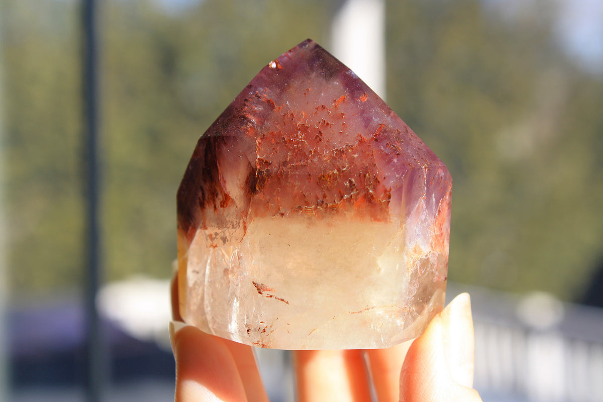 Red Dreamcoat Lemurian seed quartz tower with Super 7 inclusions and a Lemurian quartz core.