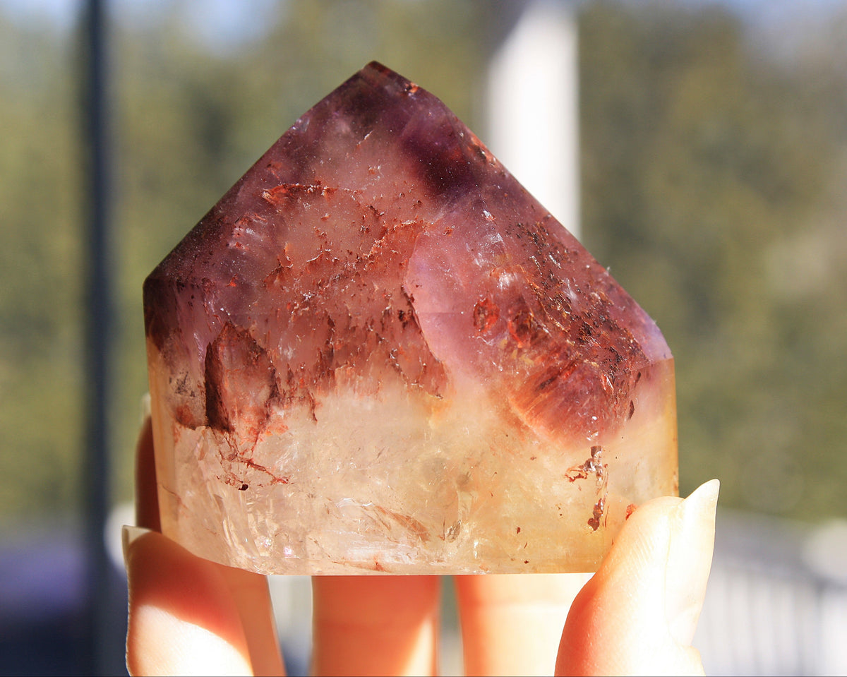 Red Dreamcoat Lemurian seed quartz tower with Super 7 inclusions and a Lemurian quartz core.