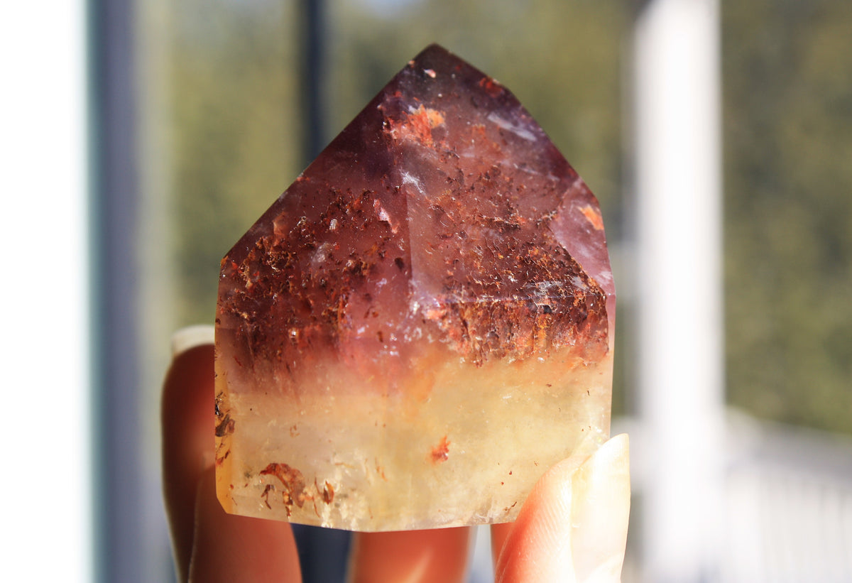 Red Dreamcoat Lemurian seed quartz tower with Super 7 inclusions and a Lemurian quartz core.