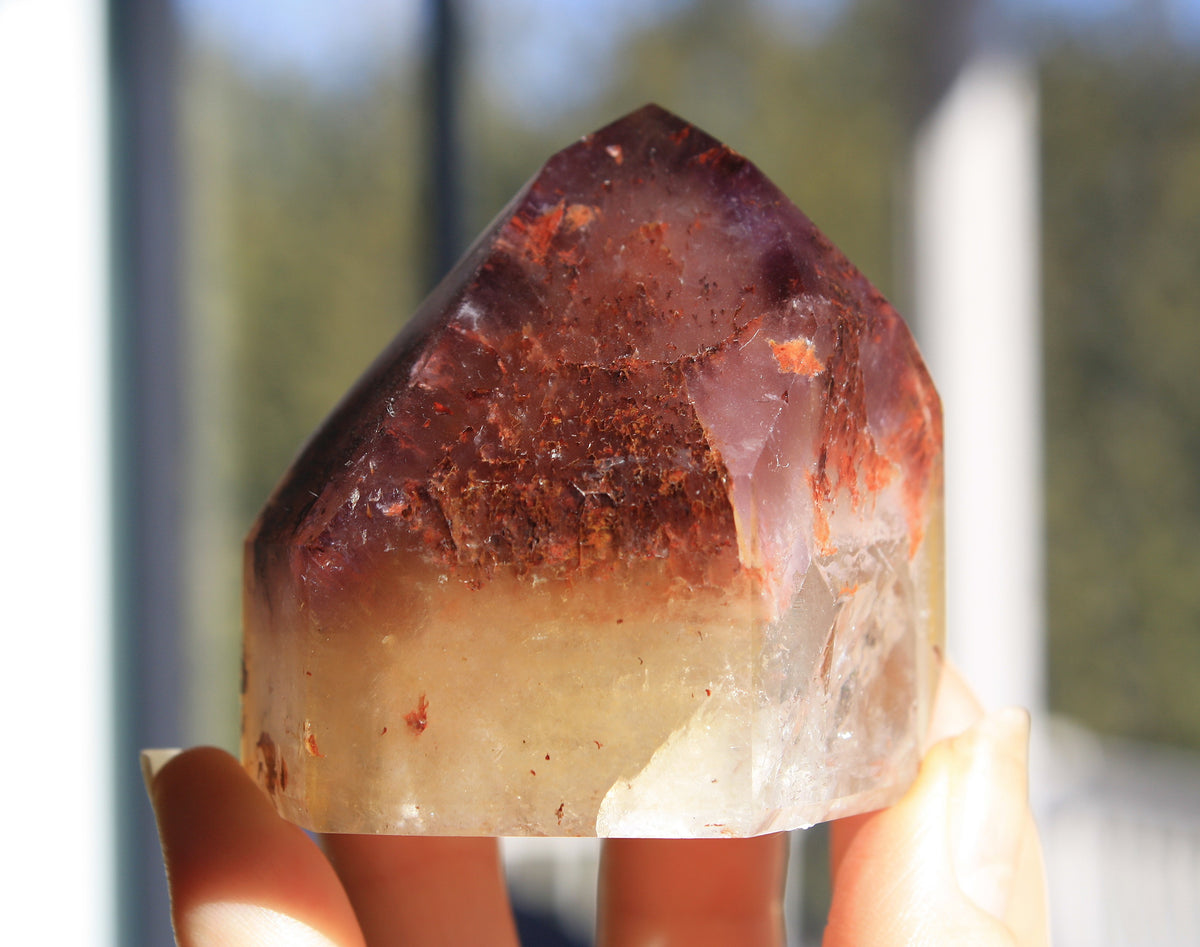 Red Dreamcoat Lemurian seed quartz tower with Super 7 inclusions and a Lemurian quartz core.