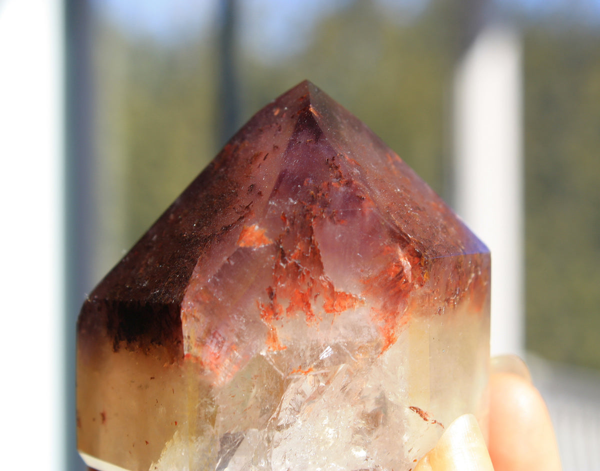 Red Dreamcoat Lemurian seed quartz tower with Super 7 inclusions and a Lemurian quartz core.