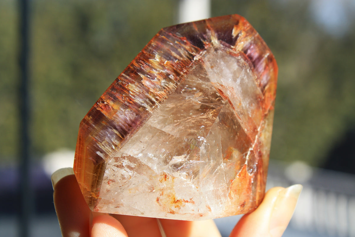 Red Dreamcoat Lemurian seed quartz tower with Super 7 inclusions and a Lemurian quartz core.