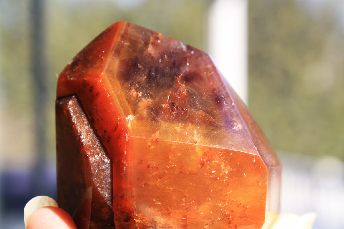 Red Dreamcoat Lemurian seed quartz tower with Super 7 inclusions and a Lemurian quartz core.
