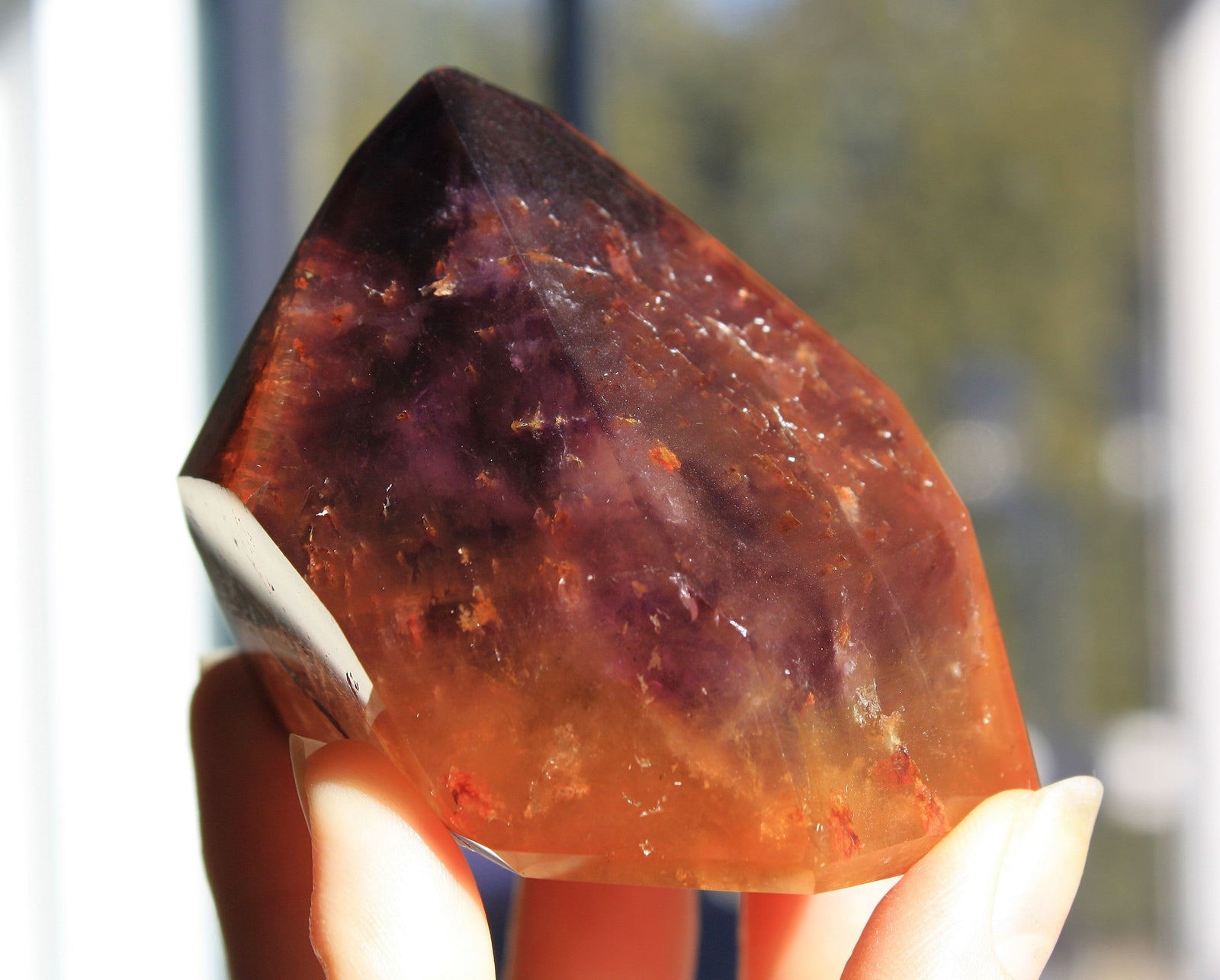 Red Dreamcoat Lemurian seed quartz tower with Super 7 inclusions and a Lemurian quartz core.