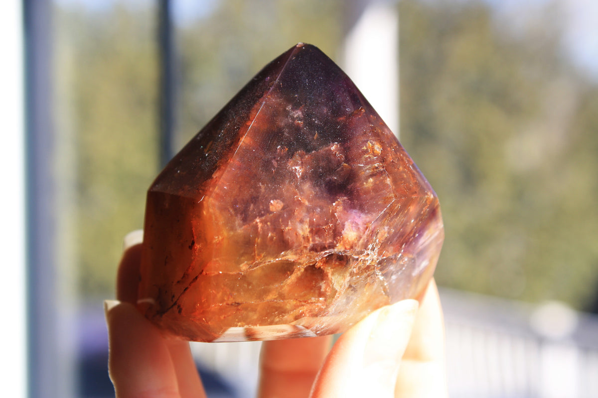 Red Dreamcoat Lemurian seed quartz tower with Super 7 inclusions and a Lemurian quartz core.