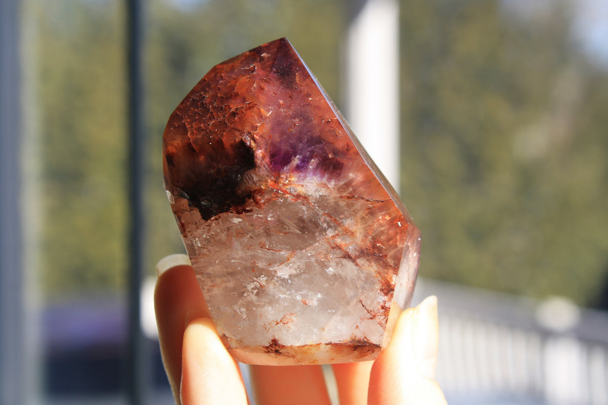 Red Dreamcoat Lemurian seed quartz tower with Super 7 inclusions and a Lemurian quartz core.