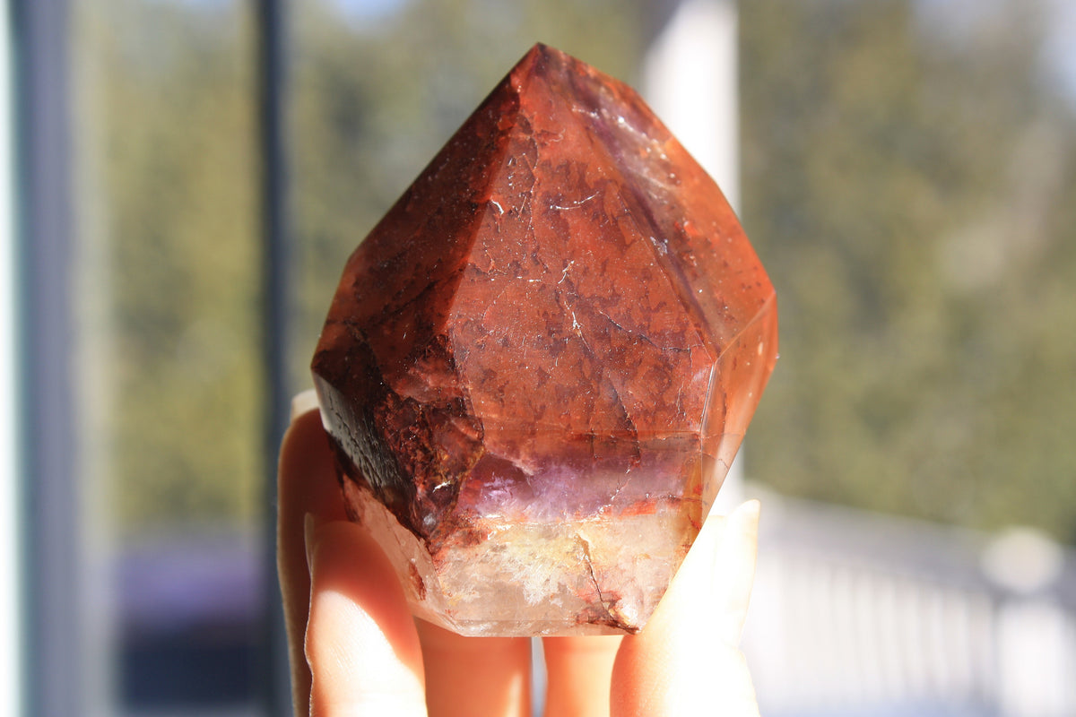 Red Dreamcoat Lemurian seed quartz tower with Super 7 inclusions and a Lemurian quartz core.