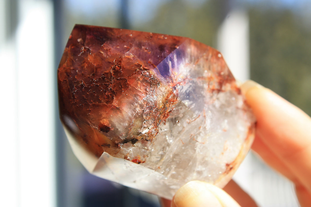 Red Dreamcoat Lemurian seed quartz tower with Super 7 inclusions and a Lemurian quartz core.