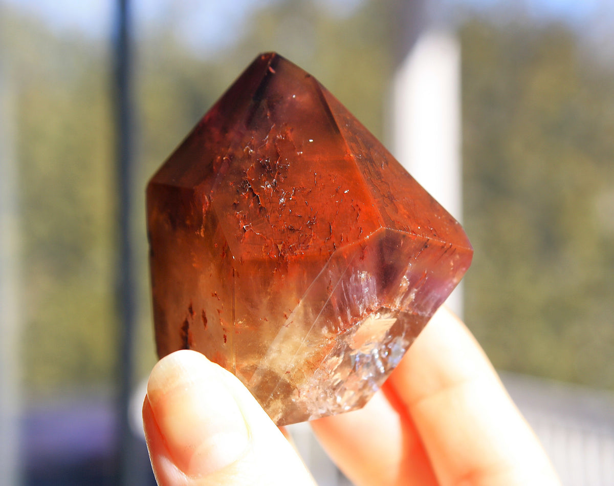 Red Dreamcoat Lemurian seed quartz tower with Super 7 inclusions and a Lemurian quartz core.