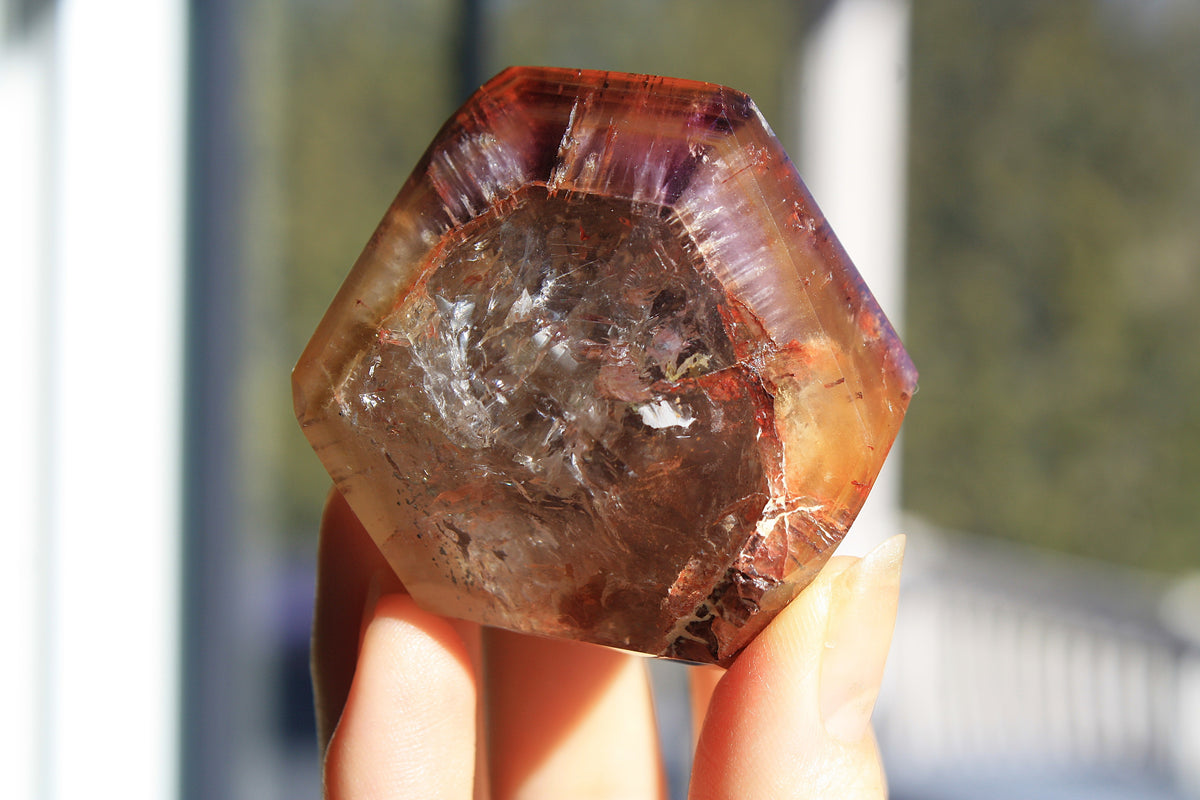 Red Dreamcoat Lemurian seed quartz tower with Super 7 inclusions and a Lemurian quartz core.