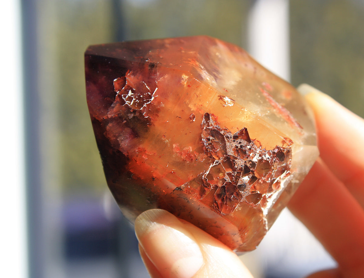 Red Dreamcoat Lemurian seed quartz tower with Super 7 inclusions and a Lemurian quartz core.