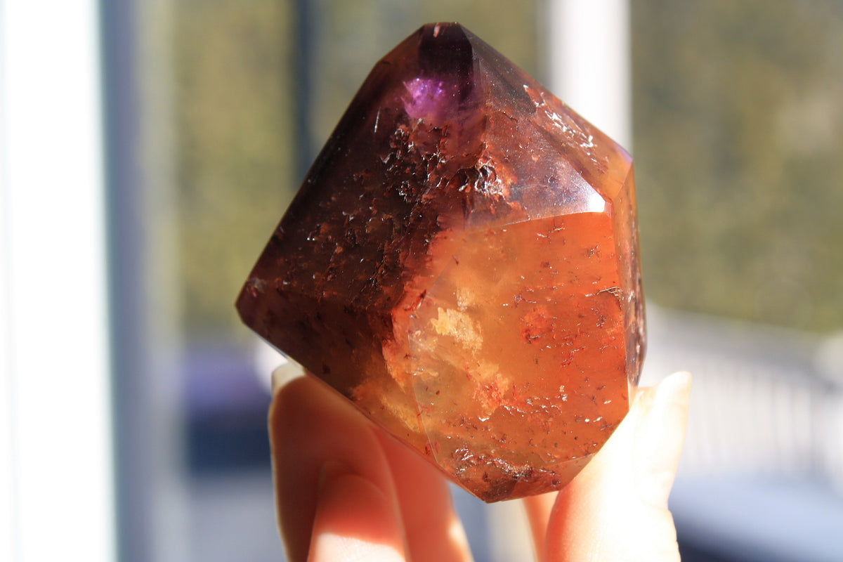 Red Dreamcoat Lemurian seed quartz tower with Super 7 inclusions and a Lemurian quartz core.