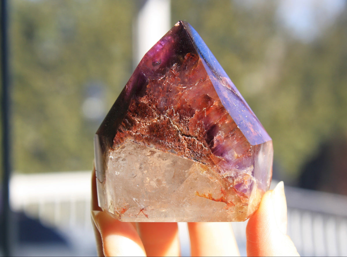 Red Dreamcoat Lemurian seed quartz tower with Super 7 inclusions and a Lemurian quartz core.