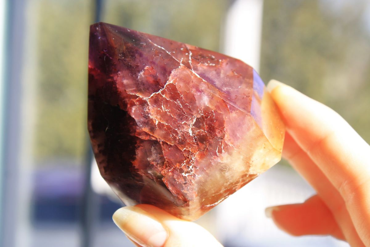 Red Dreamcoat Lemurian seed quartz tower with Super 7 inclusions and a Lemurian quartz core.